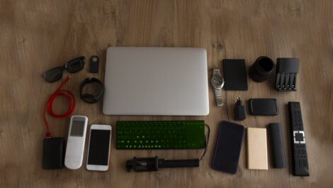 An assortment of electronic devices set on a wooden surface.